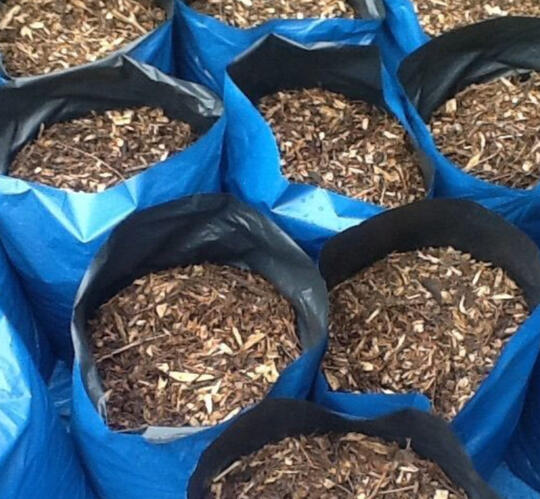 Blue bags filled with natural woodchip