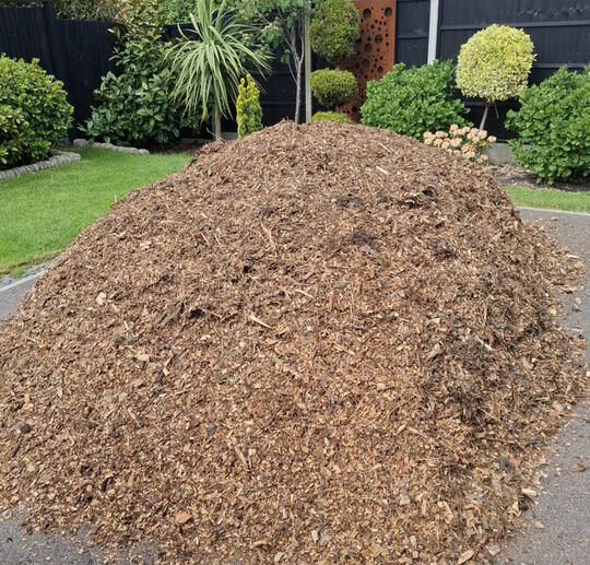 Loose pile of natural woodchip on a driveway